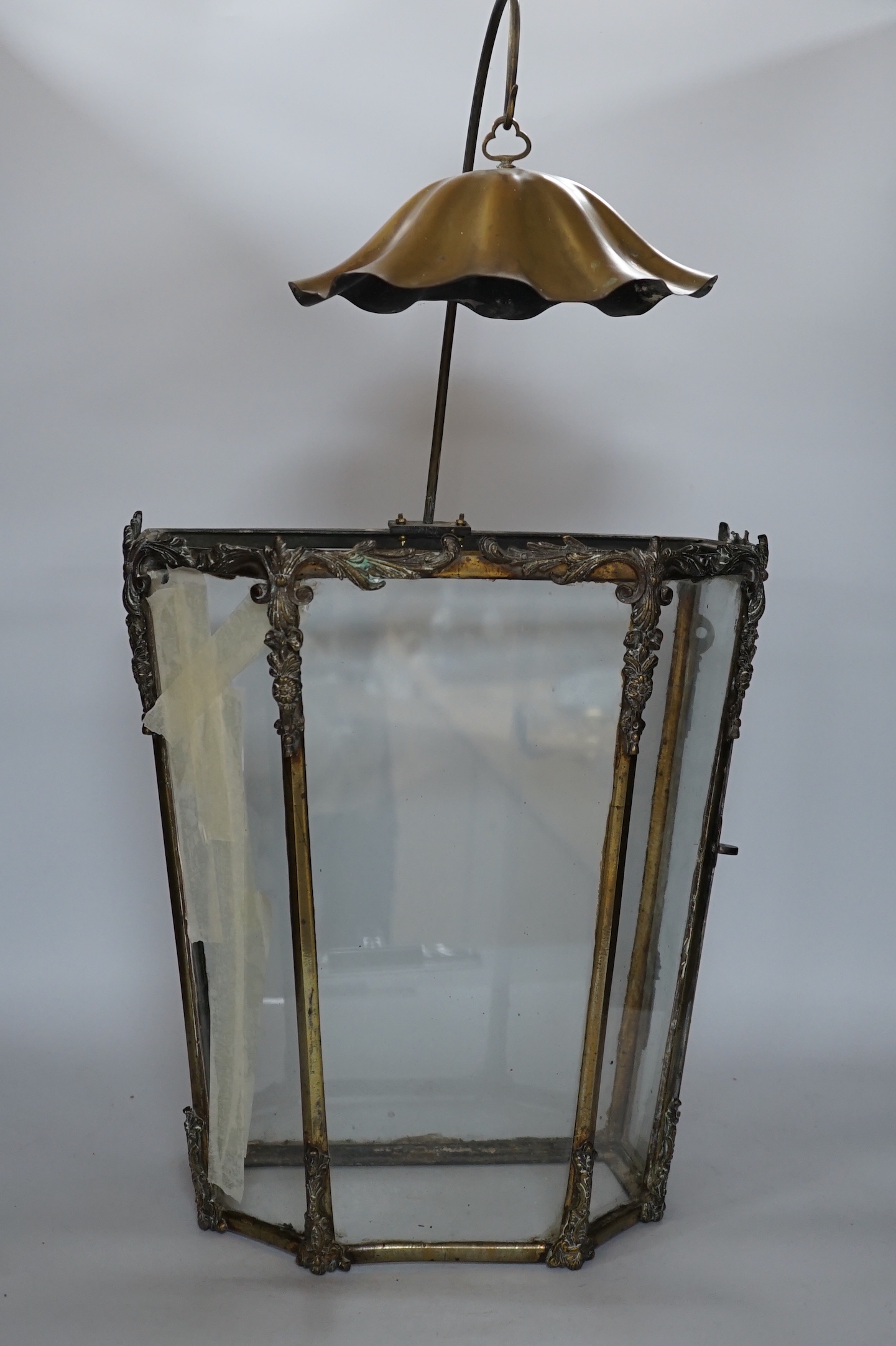 A 19th century brass framed porch lamp with applied scrolled decoration, 65cm high